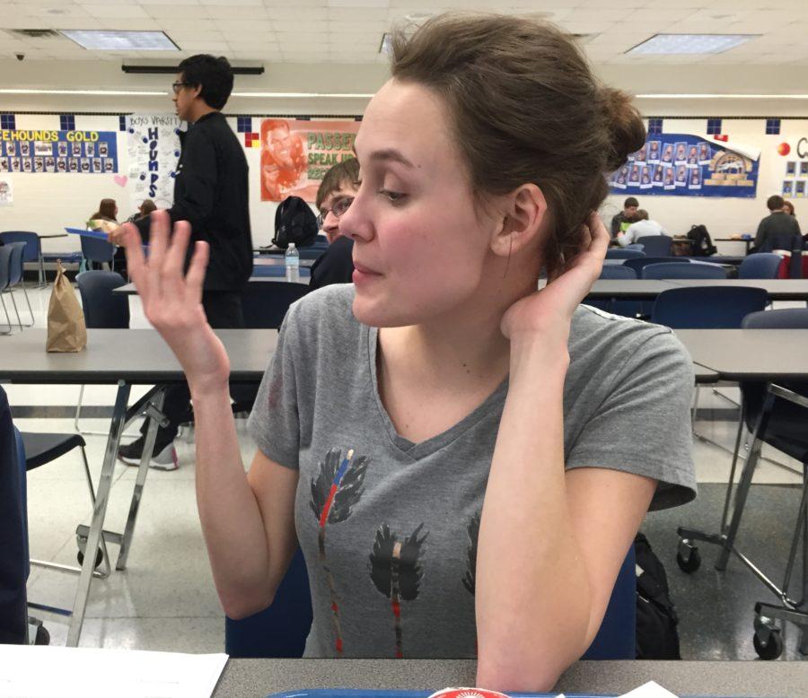 Junior Megan Armstrong talks to her friend at lunch. Armstrong said she plans to attend the Medical Academic Center field trip on the cardiovascular system day because she wants to be a cardiologist.