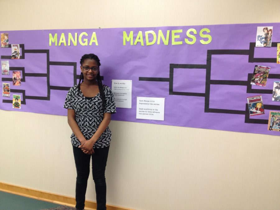Johanne Vincent, media aide and sophomore, stands in front of the Manga Madness bracket. Vincent said her favorite manga on the list is Fairy Tail. JENNY ZHAO/PHOTO