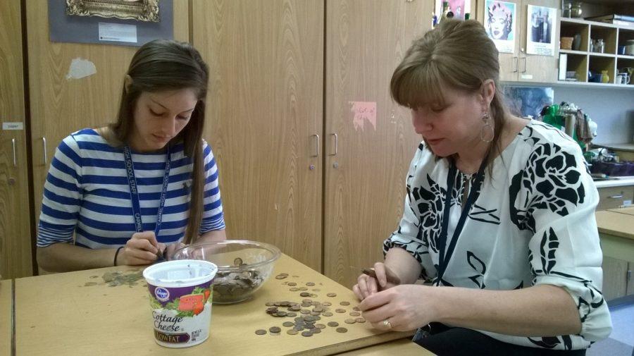 During Art Club’s March 18 meeting, student teacher Lauren Saunders and Art Club sponsor Jennifer Bubp scrape epoxy glue off of pennies. Bubp said the art department would use the “recovered” pennies to help fund the Scholastic Art Awards trip to New York this semester. JESSICA MO/PHOTO