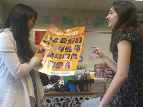 Co-presidents and seniors Ally Poveromo and Joie Li discuss fundraising events. As they look at pictures of patients who had leukemia, they think of ways to convey the importance of helping  those children to club members.