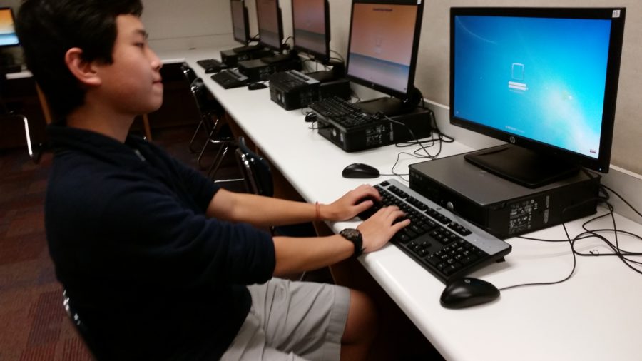Junior Neil Shah uses a laptop to work on a project. Next year, the computer lab in the media center will be renovated with big screen TVs to promote a more collaborative environment. 