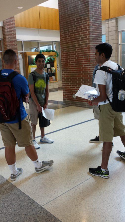 Gupta talks with friends after an AP exam. Gupta may take over as president of ISA next year, but it is still undecided. 