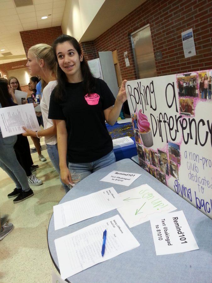 Shira Moran, club member and sophomore, promotes Baking a Difference at the freshman activity fair. The club will have its first meeting of the year on Sept. 10.
EMILY WORRELL / PHOTO