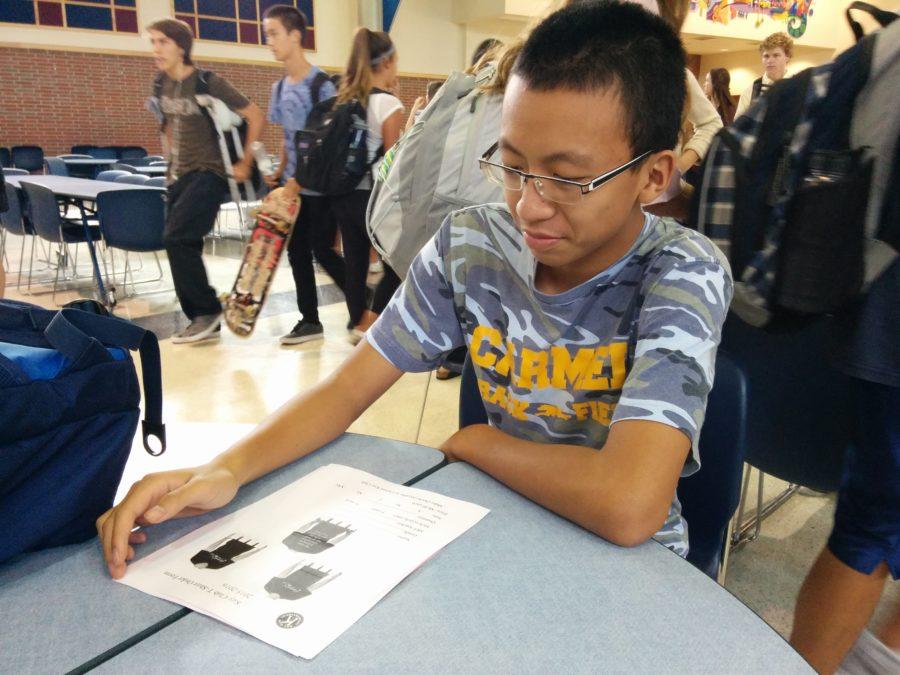 Kevin Zhangchen, Key Club member and junior, fills out a club t-shirt order form. T-shirts are available for $8, and students can pick up order forms from rooms A222 and E229.