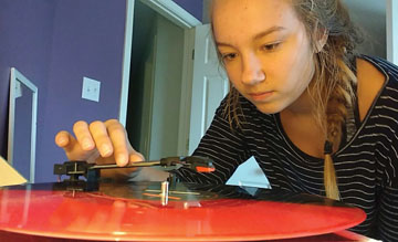 Sophomore Carly Colbert plays one of her vinyl records. Vinyl records have risen in popularity in recent years since they’re seen as ‘vintage’ and ‘hipster.’’ REBECCA QIN // PHOTO