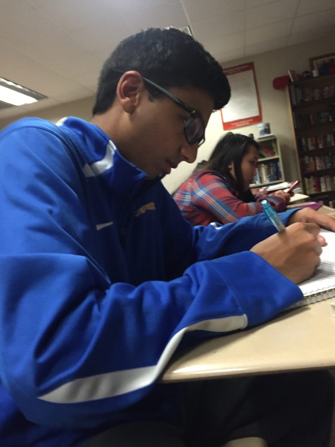Senior Senator Neil Shah reviews his notes during AP Government class. Shah said he is looking forward to seeing everyone dressed up in disco clothing at the disco dance on Jan. 22. PHOTO/ EMMA LOVE