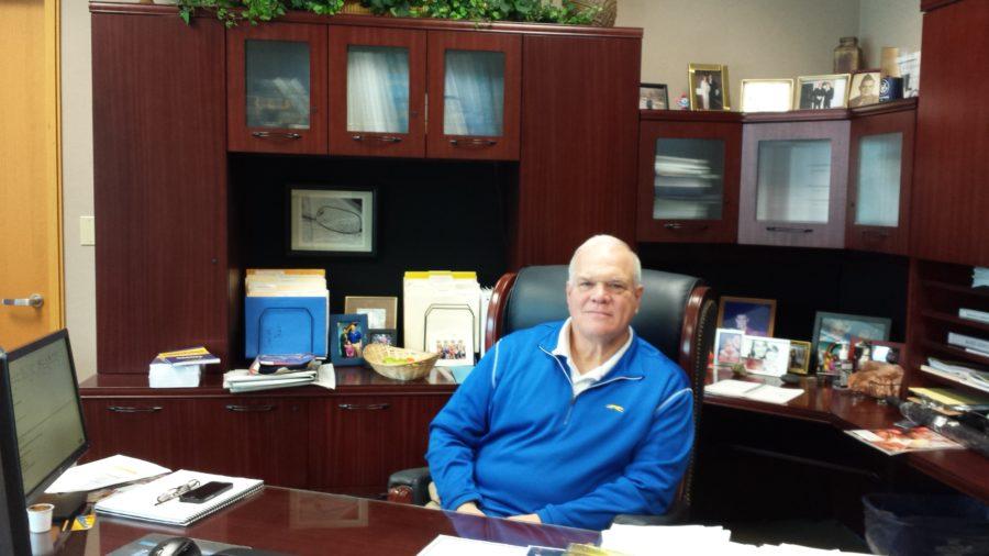 Principal John Williams works at his desk in the main office. According to Williams, students should think before they act over spring break because they do not have control over the outcomes.