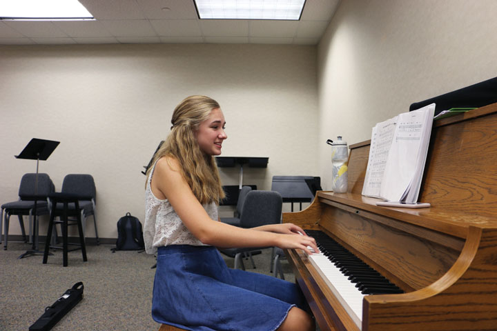 Junior Emma Hedrick plays the piano during the combos practice.