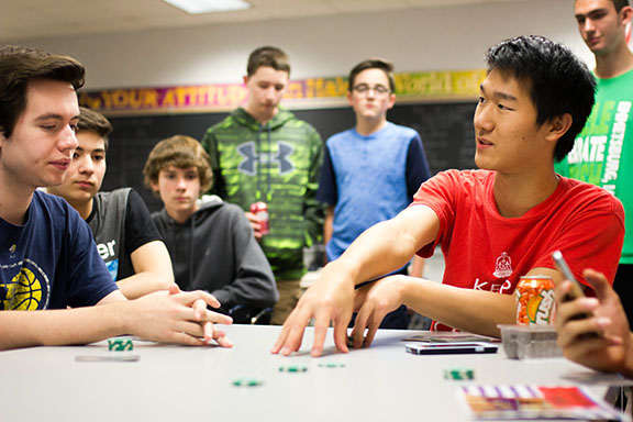 Learning Logistics: Senior Anthony Ji teaches underclassmen the rules of poker for Poker Club. Students in Poker Club meet on Wednesdays to play poker and participate in a club tournament.