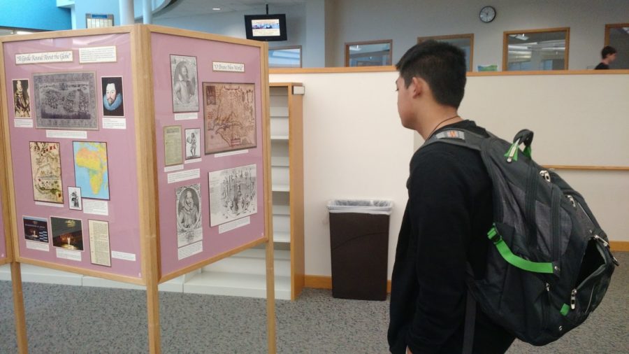 Sophomore Joseph Hsu reads the new exhibit in the Media Center. According to John Shearin, these exhibits usually coincide with what freshman classes are learning about.