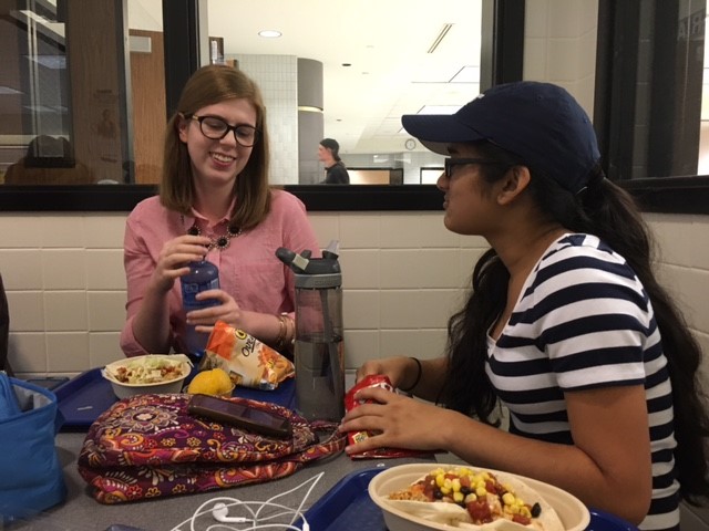 Junior Kendall Fahey (left) talks with junior Anika Bhargava (right) about their Homecoming party at lunch. According to Fahey, although the dance is mainly for freshmen and sophomores, there are alternative ways that upperclassmen can celebrate Homecoming.
