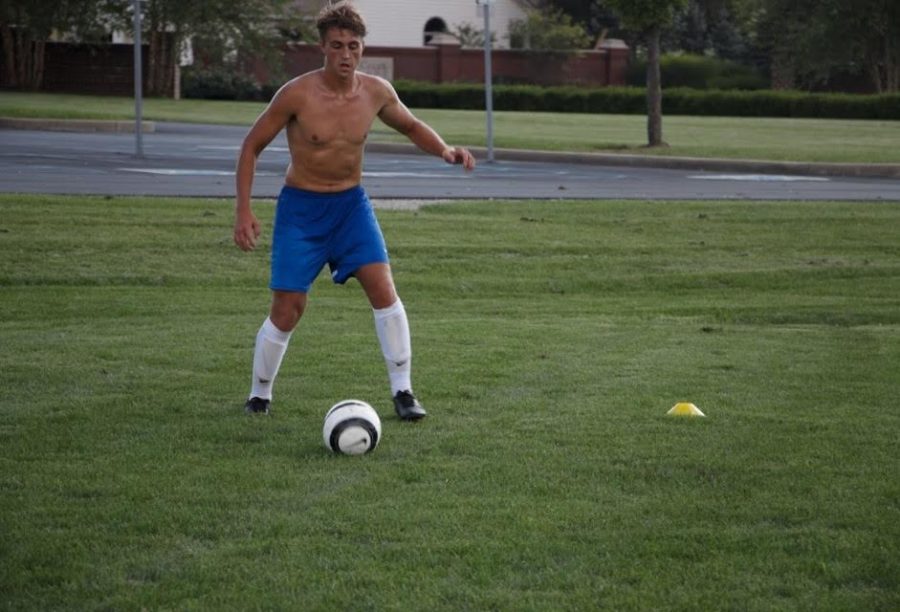 Ethan Abbott, soccer player and senior, participates in a scrimmage during practice. The team frequently does scrimmages to prepare for games and build their communication skills.
