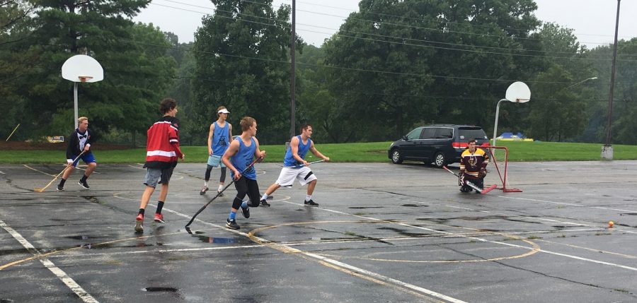 Senior Nathan Zweig is seen playing with other members of GISHL in the parking lot next to the stadium. GISHL had many scrimmages and will continue their season.