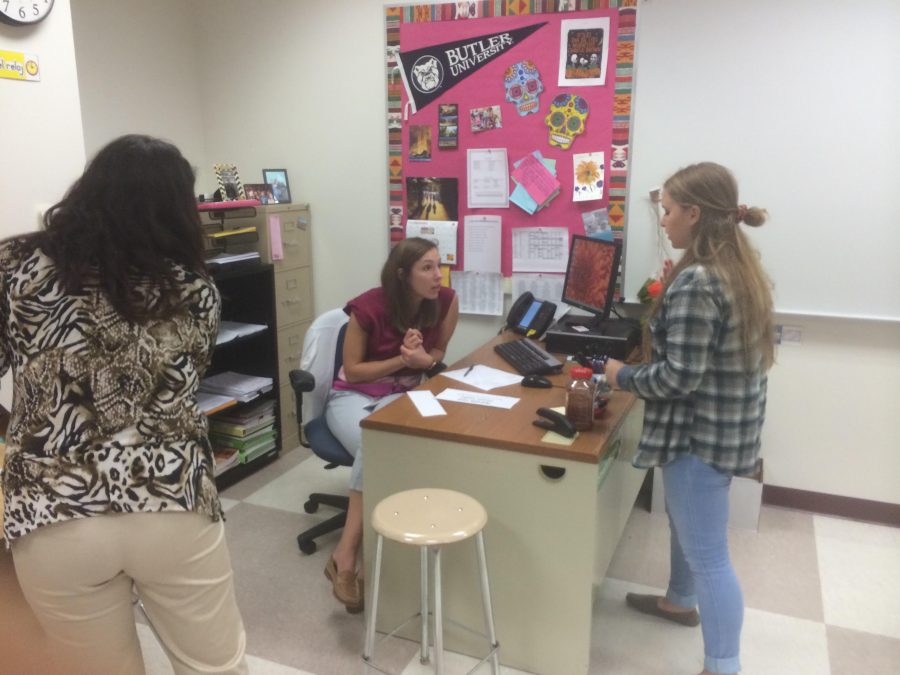 Sara Martin, Spanish Club sponsor and teacher, discusses upcoming plans with Anna Boucher, Spanish Club president and senior, during their last meeting on Nov. 16. Martin said, “For our last meeting, we watched travel vlog videos about el Dia de los Muertes, which happened in November. It’s about a travel vlogger that really got to the heart of the day of the dead: it’s not just a party; it’s a way for them to connect to the people they lost, and so it’s a happy.”