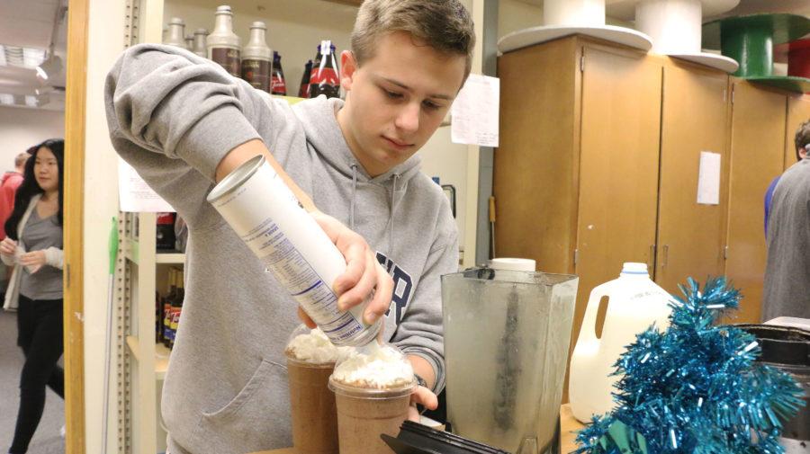 During SRT, sophomore Thomas Dziwlik makes coffee for café customers. Drew Seketa, DECA president and senior, said the new café will allow students to enjoy their drinks sitting down in the café.