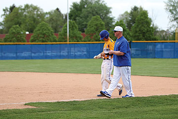 FIRST BASE HELP:
Head Coach Matt Buczkowski talks with Justin Greene, baseball outfielder and senior. The team currently has 12 seniors committed to play college baseball next year. 
KELSEY ATCHESON | photo