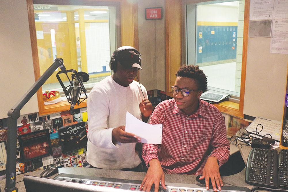 Junior David Chilemba (left) and junior Rashid “RJ” Conteh (right) go over lines for a rap. They said they also try to avoid using rap to spread their political views.