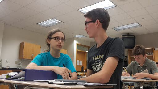 Club members Ben Ring and Kian Robinson discuss plans for the White River cleanup during their SRT class.