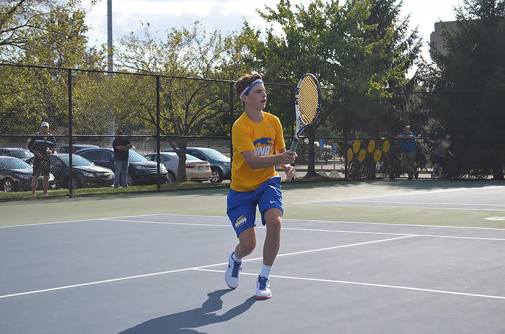 Varsity tennis player and sophomore, Presley Thieneman, volleys the ball during a match against Guerin Catholic High School. Thieneman said he has had a easy transition to CHS.