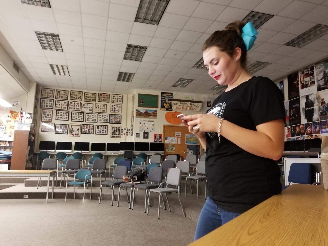 Taylor Emrick, Baking a Difference club president and senior, texts the new vice president, Morgan Goodrich, to plan their next meeting. She chose Goodrich to be the vice president last year. “I’m really excited to see what the club can do this year,” Emrick said.