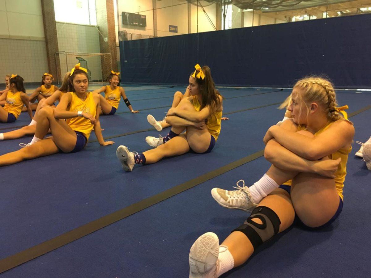 Teammates Marissa Kepler (left), McKenna Abbey (middle), and Taylor Gallagher (right), stretch as part of the team’s warm-ups. The team has recently been removed from the competition at Purdue but will compete at New Palestine on Sept. 30.