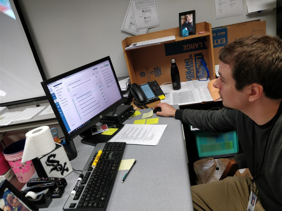 James Ziegler, Academic Super Bowl co-sponsor and social studies teacher, checks the Academic Super Bowl Canvas page. Ziegler said this year the club had many strong candidates for the captain positions.