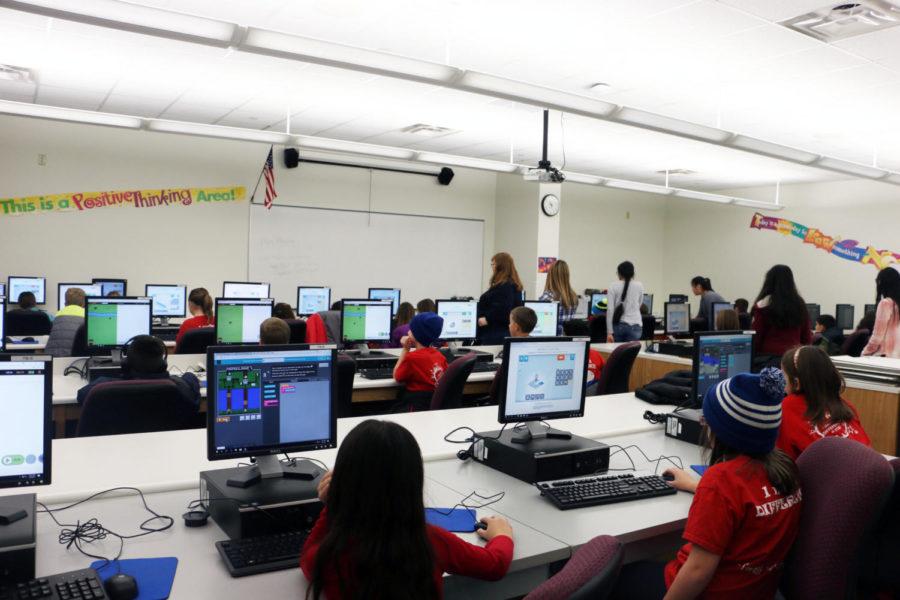 Elementary school students sit in a computer lab to work on programs organized by computer science students. The Hour of Code took place in the business halls.
