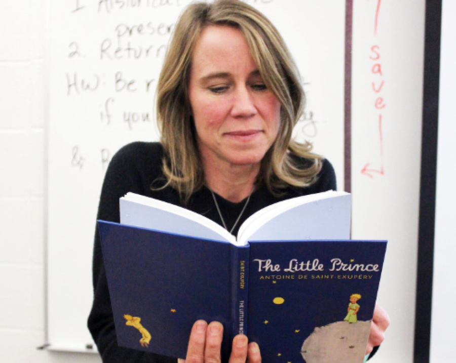 English teacher Katie Overbeck reads The Little Prince before class begins; according to Overbeck, her International Baccalaureate (IB) classes are currently reading the book in class.