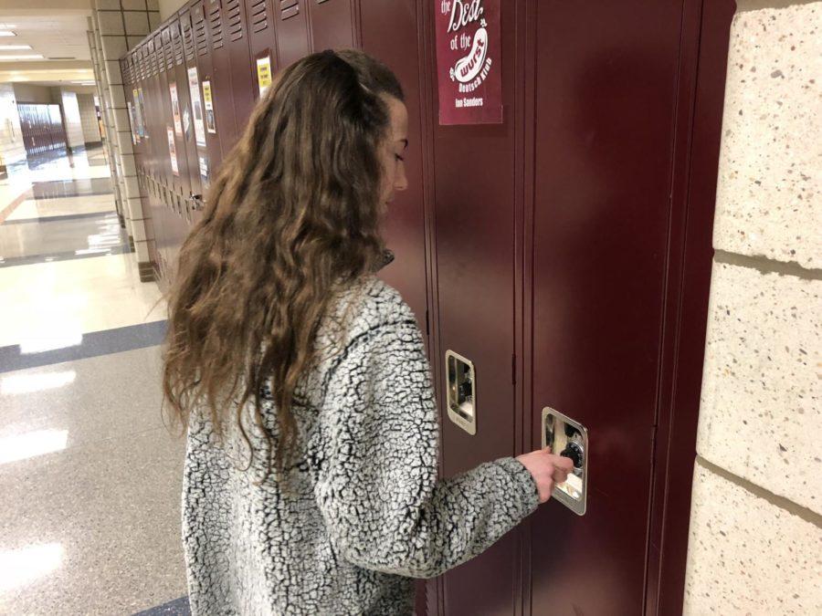 Freshman Maddy Ludwig opens her locker before class. She recently transferred to CHS from Our Lady of Mount Carmel School. 