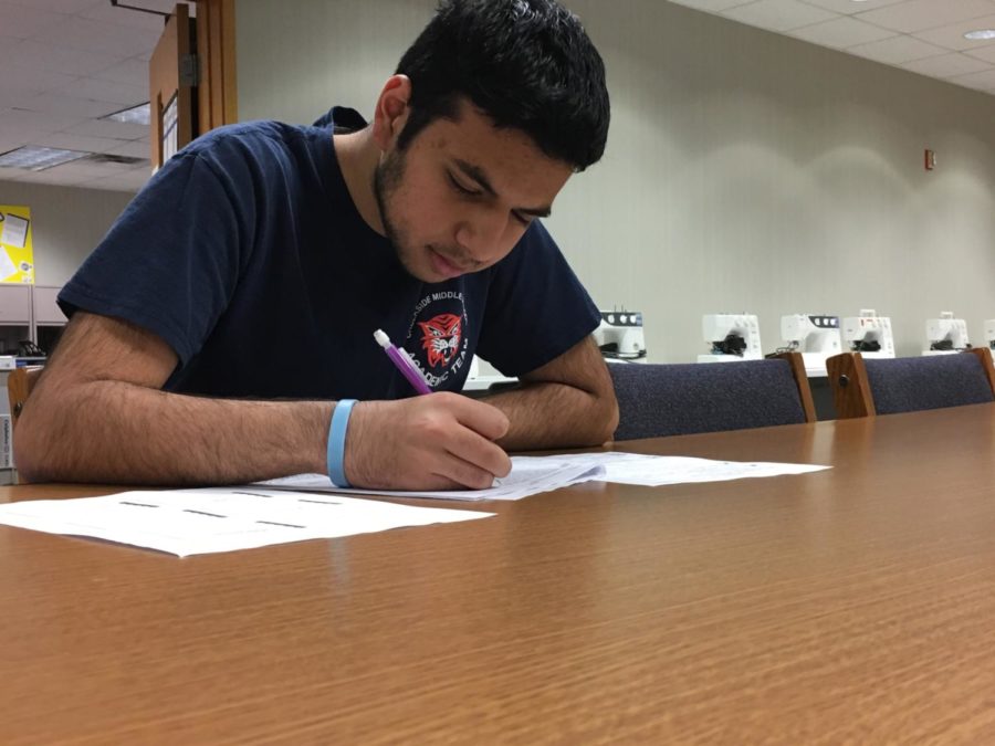 Co-president and junior Danial Tajwer looks over notes for upcoming conference. Tajwer said, “We have finished position papers (for the conference) and most have them been turned in.”