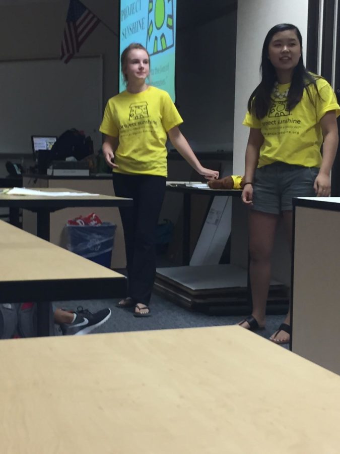 Hannah Bromm and Nyssa Qiao, Project Sunshine Co-presidents and seniors inform members on how to construct the craft kits. ​​