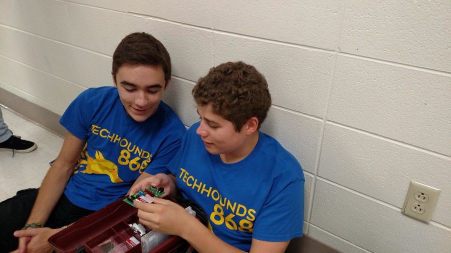 Caleb Smith, TechHOUNDS member and senior, and Derek Fronek, TechHOUNDS member and junior, study hardware before school in the industrial technology (I.T.) hallway. Smith and Fronek, along with other TechHOUNDS members, will conclude their build season this Friday, Feb. 16.

