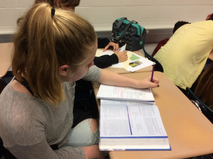 Lauren Roop, House member and senior, takes notes during class to make time for the final House events of the year. She said she is excited for the upcoming events at the end of her senior year.