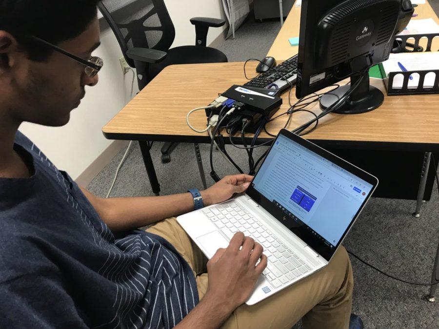 Sophomore Roshan Mahesh works on his written paper for the upcoming ICDC competition. DECA students have utilized their SRT time to prepare for competitions as well as gain feedback from the teachers. 