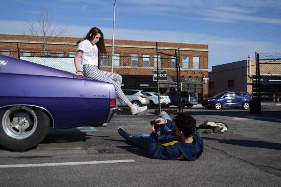 Sophomore Ayman Bolad takes a photo of sophomore Maclean Wood on a retro car. Bolad contacted Wood to collaborate on setting up the outdoor photo shoot. 
