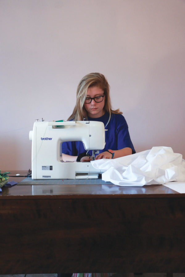 Natalie Crispin, 4-H member and sophomore, works on a 4-H sewing project. Crispin said her mother used to compete in the same events as well. 