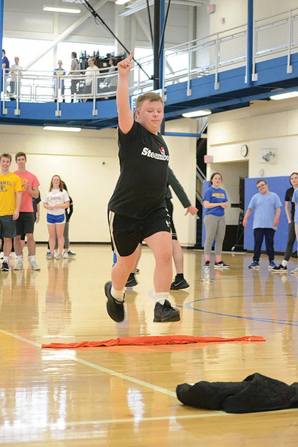 Connor Weindorf, Unified Track member and junior, does a victory jump after completing an event at practice. According to Halle Throgmorton, Unified Track helper and junior, Unified Track provides a fun and competitive environment for participants.