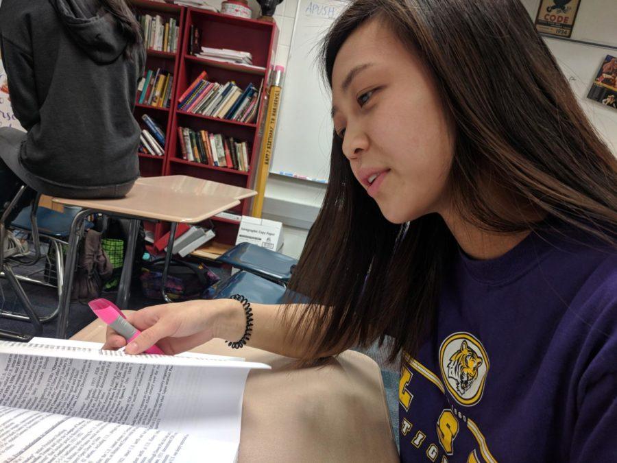 Junior Jocelyn Shan works on her AP U.S. History review. Shan said that building a new elementary school was not the best option to solve the distribution issue.