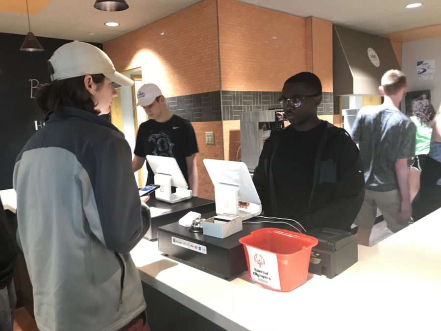 Dominick Sanford, DECA member and senior, takes a students order in the Carmel Café. Sanford said, The Carmel Café is a great way for students like me to gain valuable experiences in different areas of business. 