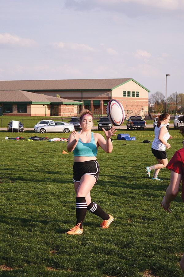 Maddie Schultz, rugby player and junior, catches the ball during a drill. Practices are held at Monon Trail Elementary School.