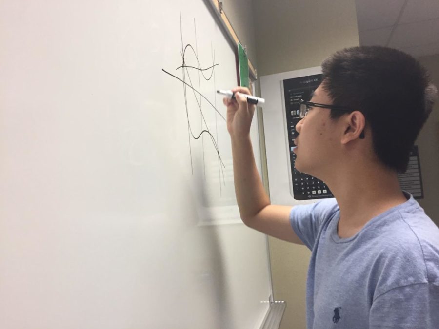  Co-president and senior Kevin Liu finds different approaches to solve a difficult math problem. The members talked about this problem throughout the club meeting. 