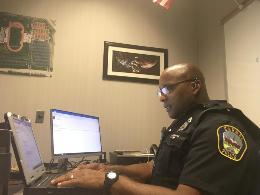 School Resource Officer (SRO) Scott Moore reviews an email sent to all SROs at CHS regarding restricted access to CHS entrances in the morning. Moore said these measures are important because they will improve school safety both during and after school hours.