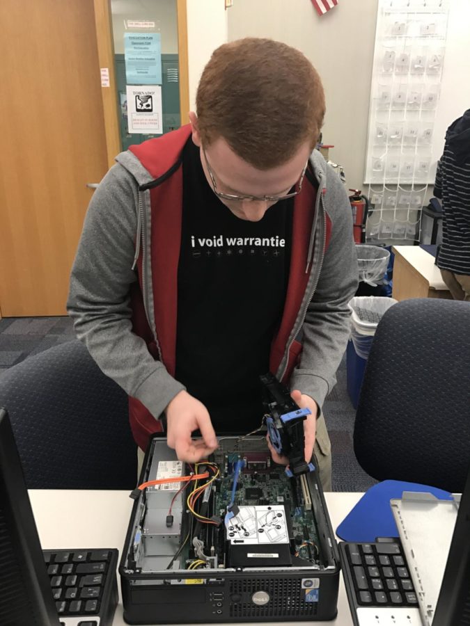Club member Bo Sendi starts off a weekly meeting by checking the software of a computer donated by Net-Literacy. Sendi has been a club member since sophomore year. 
