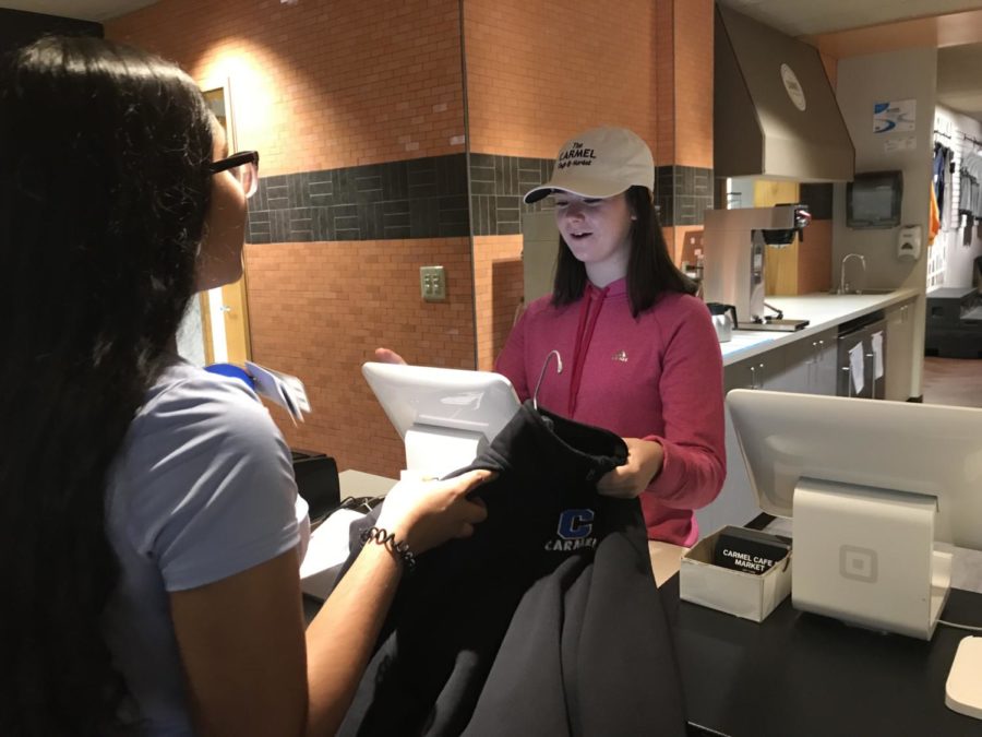 Sophomore Carolyn Rake helps a customer check out in the Carmel Café during SRT. She said, I love working in the Carmel Café because you get to interact with a lot of people and meet them as well. 