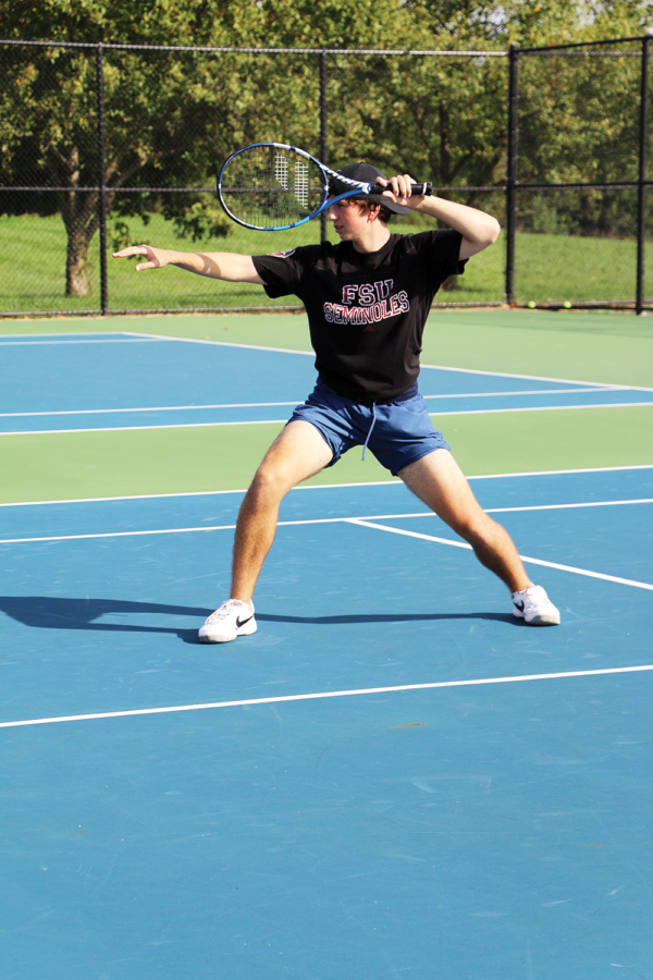 Casual Competition: 
Abraham Fiore, Ex-O squad member and senior, hits a forehand during a practice match in one of Ex-O’s practice. Fiore said the team helps them with their game while also keeping it casual when they play.