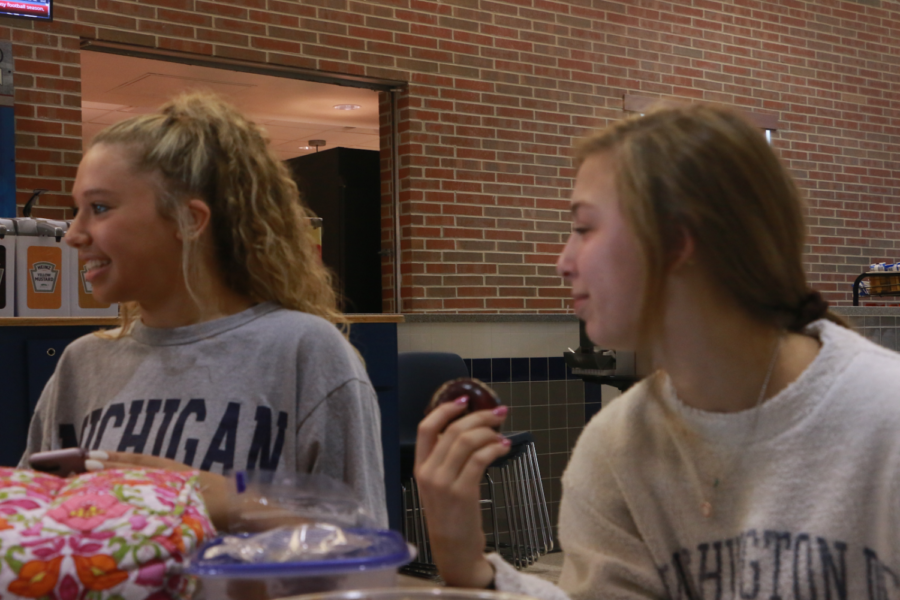 Juniors and dancers Lexi Dungey (left) and Maddy Massa (right) have lunch together as team members. The girls try to balance school, dance and socialization. “When we are together outside of practice, we bond in ways that benefit our sportsmanship and time together on the team,” Massa said. 