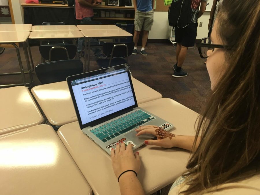 Senior Hannah Kosc previews the anonymous alert page through myCCS. Kosc said she has used the system before, and the guaranteed anonymity made the decision to report much easier. 