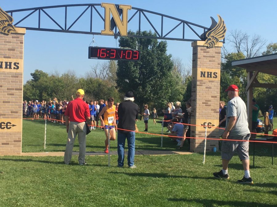 Senior Calvin Bates crosses the finish line at the Sectional meet on Oct. 6. He placed second and the team placed first overall.