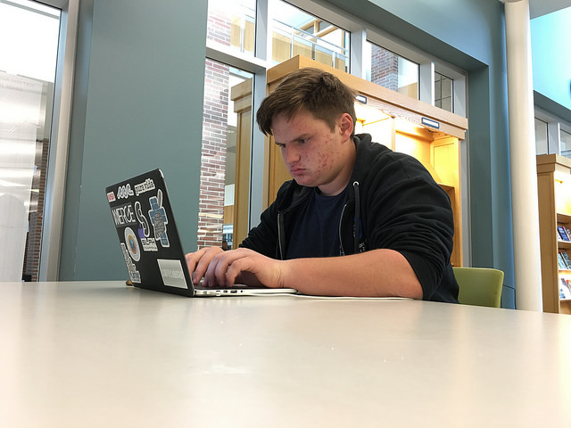 Senior Struggles: Senior Gabe Santee revises his Common Application essays during G4 on his release period at the library. Santee corrected the grammatical errors on his Purdue supplemental essays.
