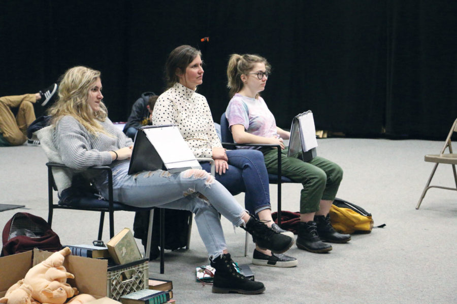 Performing arts teacher Maggie Cassidy (middle) sits with sophomore Mikayla “Kayla” Phillips (left) and junior Emily Sanders (right) as she watches theater students rehearse their scenes from the fall play. Cassidy said serious plays are harder to act and convey emotion.